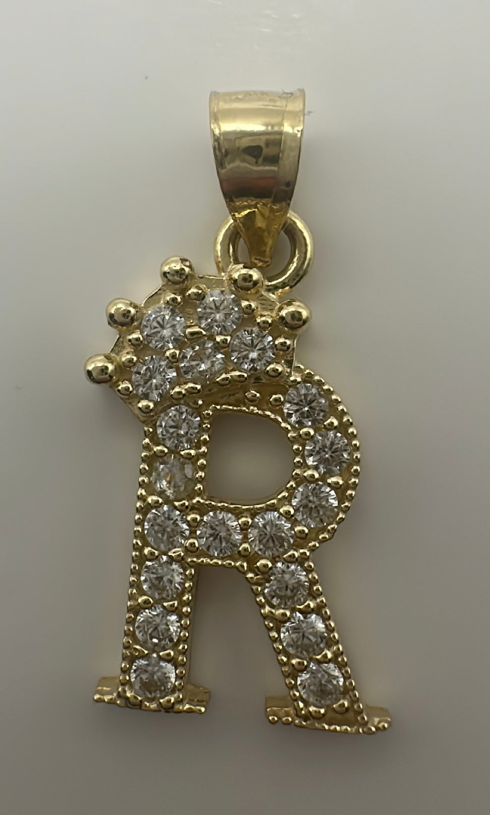 Small initial pendant letter "R"